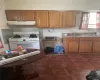 Kitchen featuring white range with gas cooktop, sink, and dark parquet floors