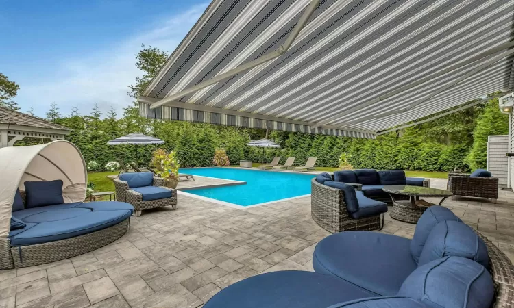 View of swimming pool featuring outdoor lounge area and a patio