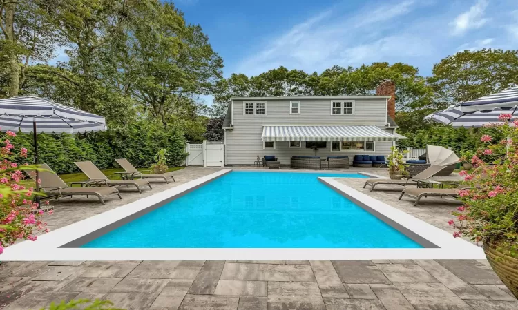 Rear view of property with a patio and an outdoor hangout area