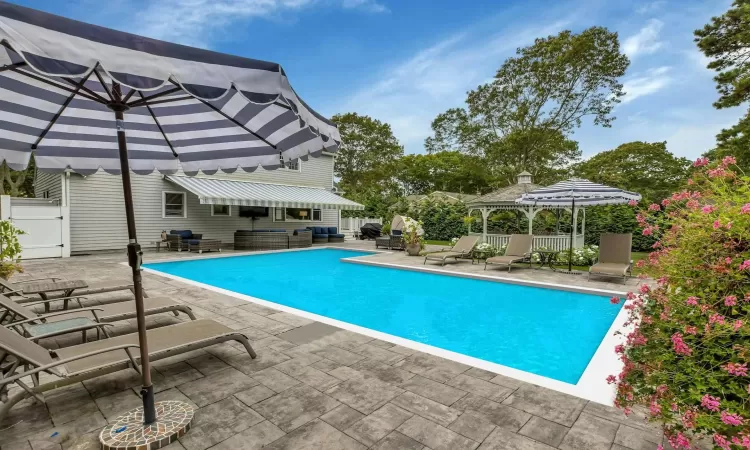 View of pool featuring a gazebo and a patio area