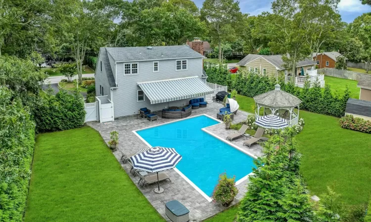 View of swimming pool featuring a gazebo, a patio area, a lawn, and an outdoor hangout area