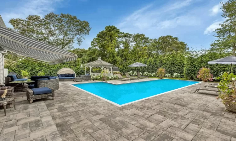 View of pool featuring a gazebo and a patio