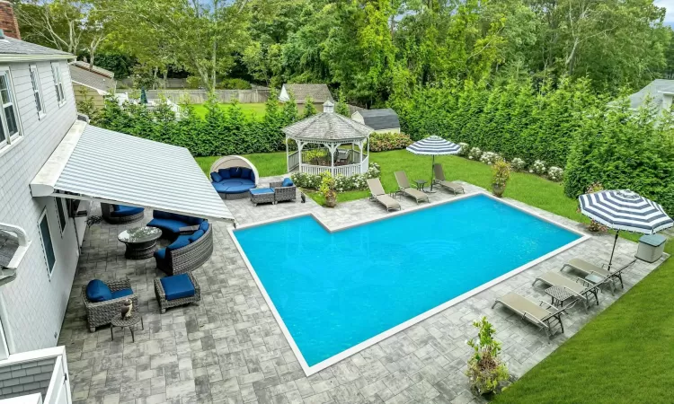 View of pool with a gazebo, a lawn, a patio, and an outdoor hangout area