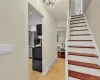 Stairway featuring tile patterned flooring, an inviting chandelier, and a baseboard heating unit