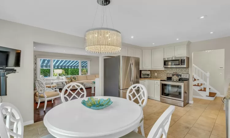 Dining room featuring a chandelier and light tile patterned floors