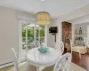 Dining area featuring a fireplace, light hardwood / wood-style flooring, and a baseboard heating unit