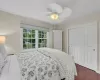 Bedroom featuring ceiling fan and dark wood-type flooring