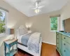 Bedroom with ceiling fan and dark wood-type flooring