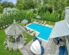 View of swimming pool featuring a gazebo, a patio area, and a lawn