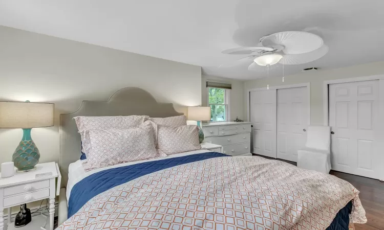 Bedroom featuring dark hardwood / wood-style floors and ceiling fan