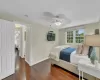 Bedroom with ceiling fan and dark wood-type flooring