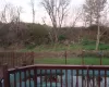 Deck at dusk with a yard and a pool