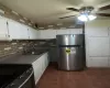 Kitchen featuring ceiling fan, white cabinetry, sink, and appliances with stainless steel finishes