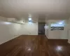 Unfurnished room featuring dark hardwood / wood-style flooring and sink