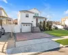 Front facade with a garage and a front lawn