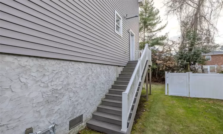 View of side of property with a lawn