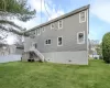 Rear view of house featuring a lawn