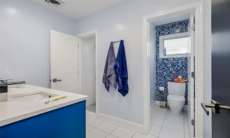 Bathroom with tile patterned flooring, vanity, and toilet