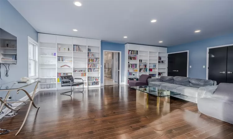 Living room with dark wood-type flooring