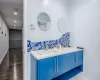 Bathroom featuring decorative backsplash, vanity, and wood-type flooring