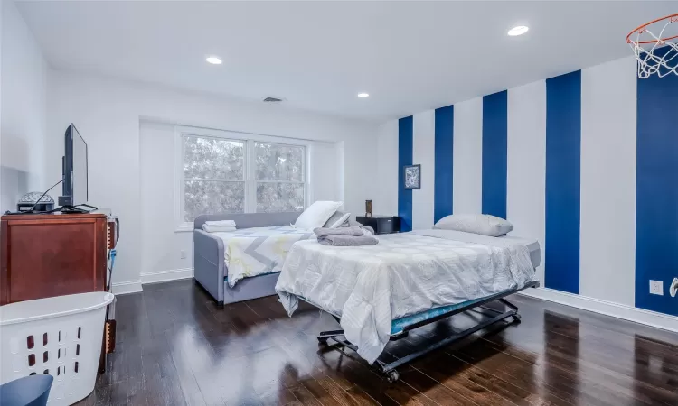 Bedroom with dark wood-type flooring