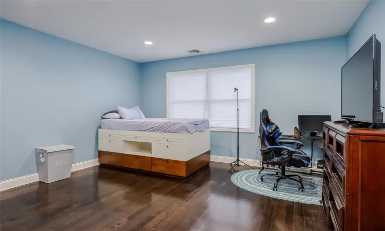 Bedroom featuring dark wood-type flooring