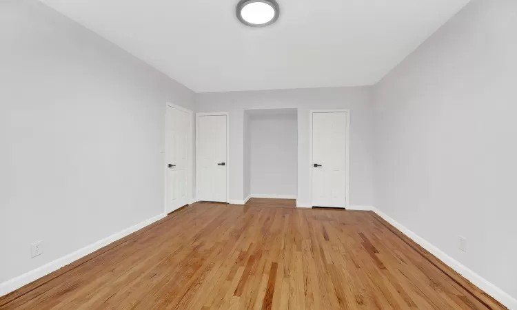 Empty room with light hardwood / wood-style flooring