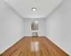 Unfurnished room with light wood-type flooring and radiator heating unit