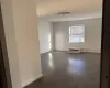 Unfurnished room with dark wood-type flooring