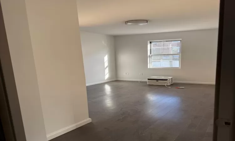 Unfurnished room with dark wood-type flooring