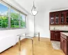 Dining room featuring sink, radiator, and light hardwood / wood-style flooring