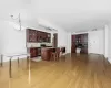 Kitchen featuring light wood-type flooring, appliances with stainless steel finishes, a center island, and a kitchen breakfast bar