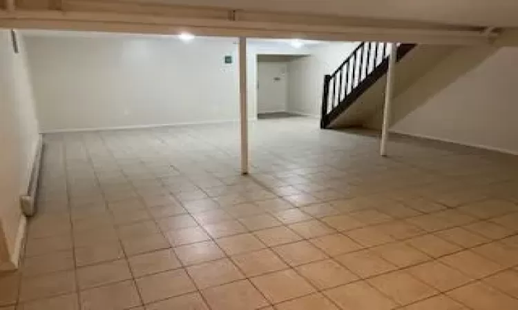 Basement featuring light tile patterned floors