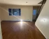 Empty room featuring dark wood-type flooring