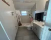 Bathroom with tile patterned flooring, a shower with curtain, vanity, and toilet