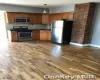 Kitchen with backsplash, dark hardwood / wood-style floors, and appliances with stainless steel finishes