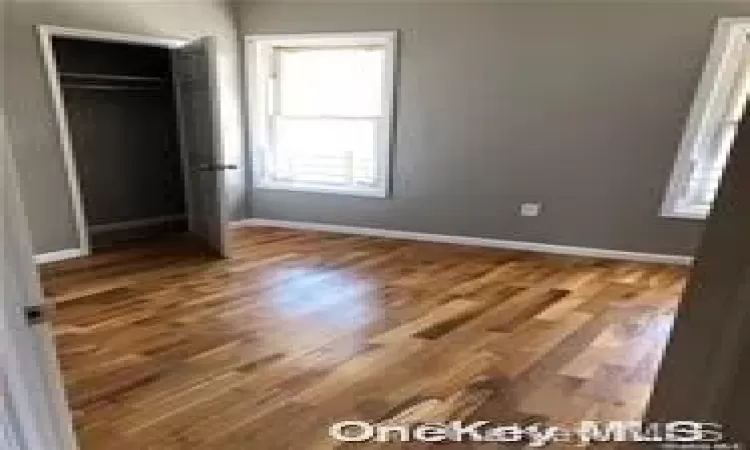 Unfurnished bedroom featuring wood-type flooring and a closet