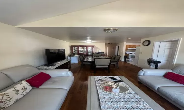 Living room with wood-type flooring and lofted ceiling