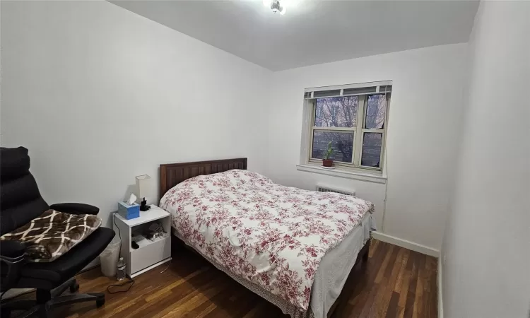 Bedroom with dark wood-type flooring