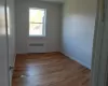 Spare room with radiator heating unit and light hardwood / wood-style flooring