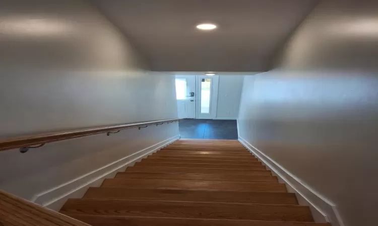 Staircase with hardwood / wood-style flooring