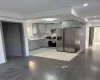 Kitchen featuring gray cabinets, stainless steel appliances, and hardwood / wood-style flooring