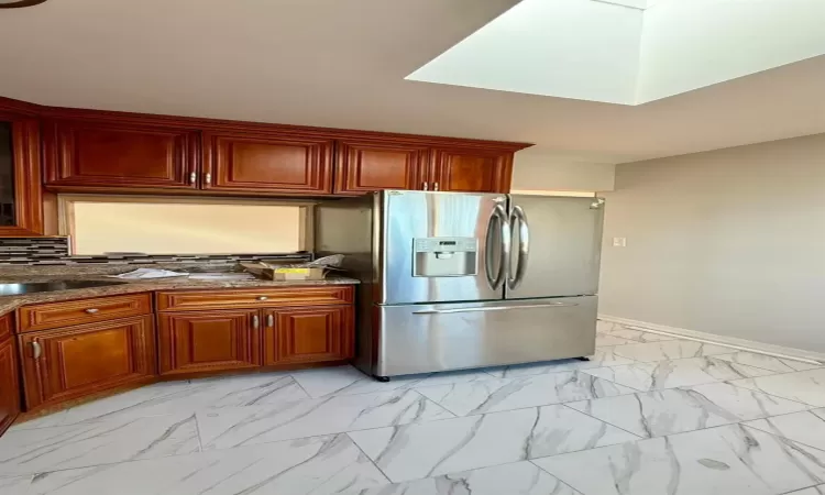 Kitchen featuring stainless steel fridge and sink