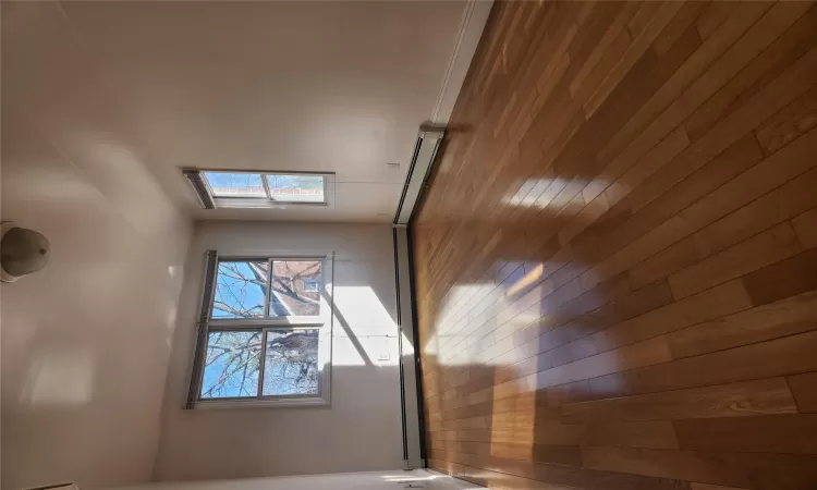 Spare room featuring hardwood / wood-style flooring and baseboard heating