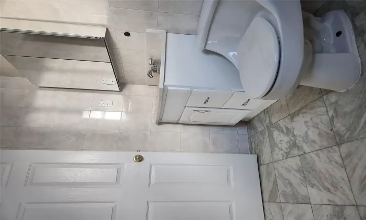 Bathroom featuring vanity and tile walls