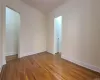 Unfurnished room with crown molding and hardwood / wood-style floors