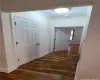 Corridor featuring dark hardwood / wood-style flooring and crown molding