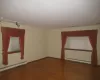 Spare room featuring dark hardwood / wood-style floors and a baseboard heating unit