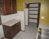 Kitchen featuring decorative backsplash, light tile patterned floors, and sink