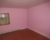 Empty room with hardwood / wood-style flooring and a baseboard heating unit